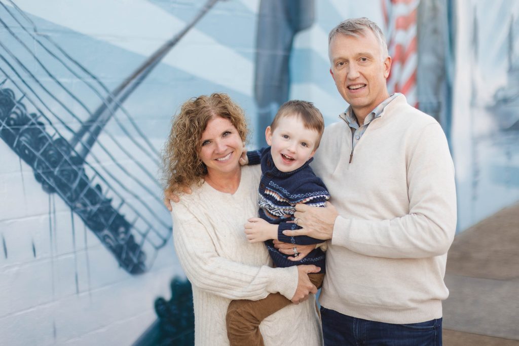 A family poses for a portrait in front of a mural in downtown Annapolis.