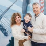 A family poses for a portrait in front of a mural in downtown Annapolis.