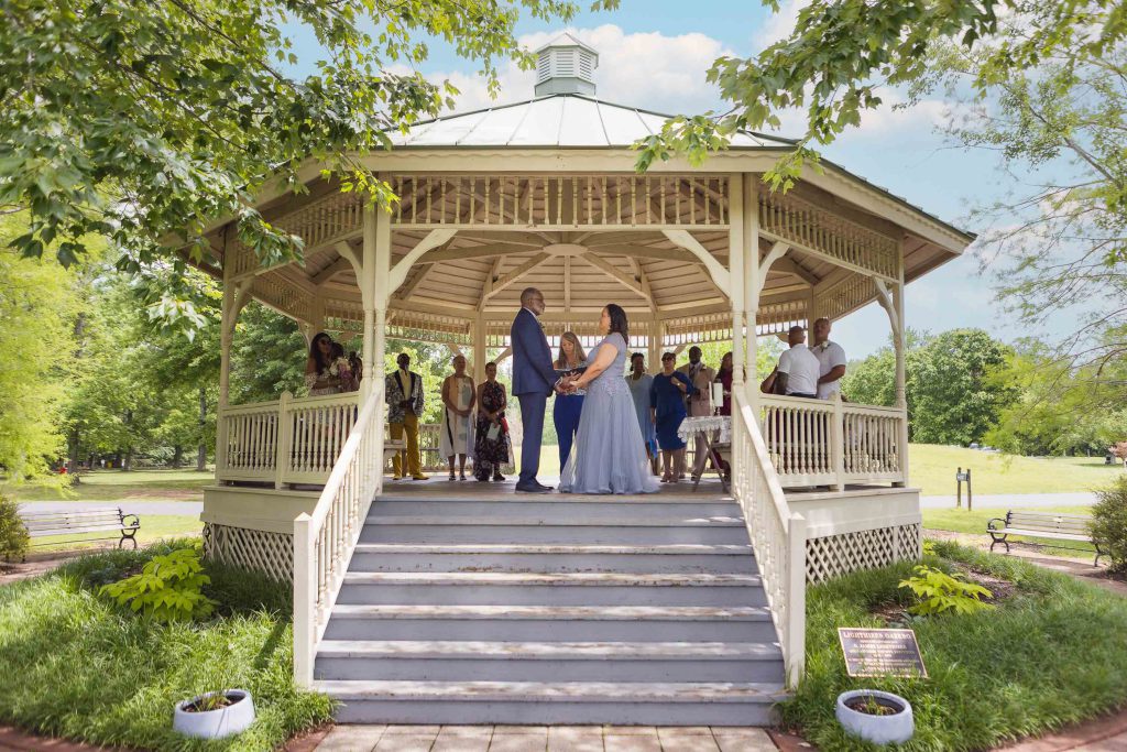 A bride and groom standing in front of a gazebo at Quiet Waters Park, Annapolis.