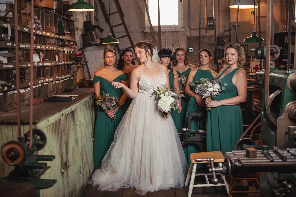 Bridesmaids in green dresses at the Baltimore Museum of Industry.
