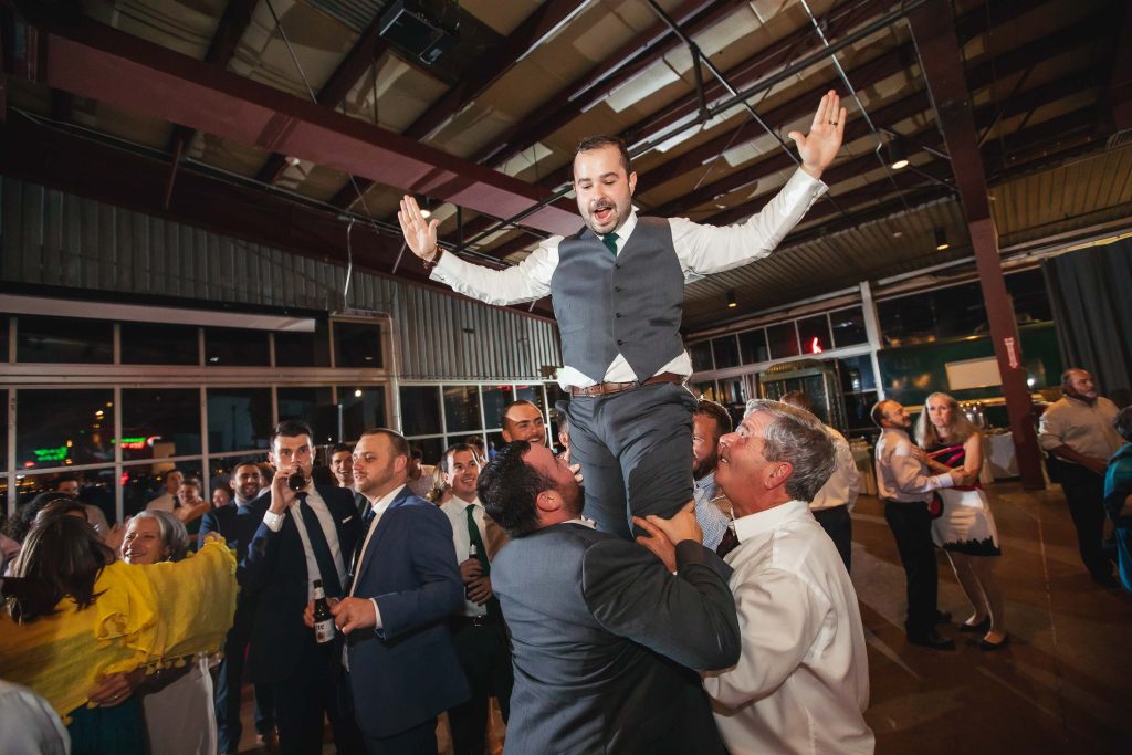 A man is being lifted up at a wedding reception in Baltimore, Maryland.