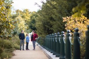 A family walks through the Bartholdi Fountain & Gardens in Washington DC.