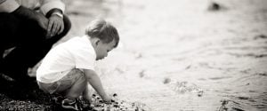 Black and white photo of a little boy playing in the water at Black Hill Regional Park.
