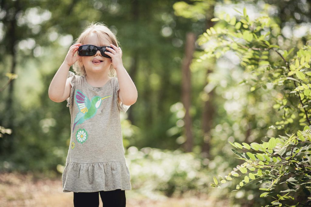 A little girl looking through binoculars at Buddy Attick Lake Park.