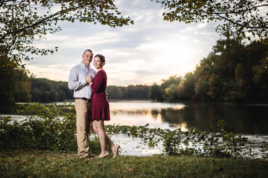 An engaged couple posing in front of Buddy Attick Lake Park.