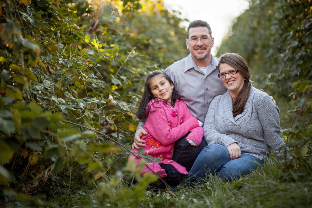 A family enjoys a day at Butler's Orchard in Germantown, Maryland, amidst a field of grapes.