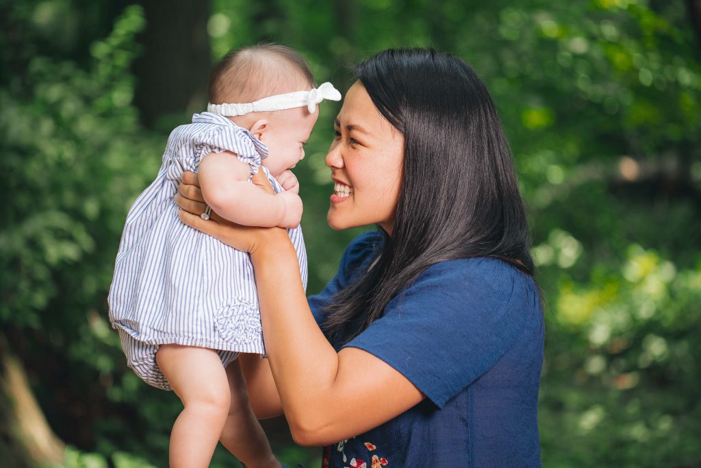 A woman holding a baby in Cabin John Regional Park.