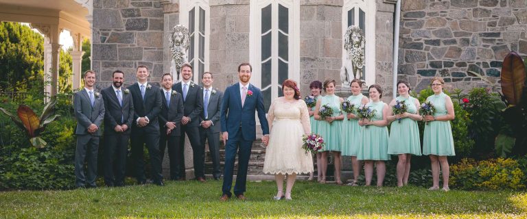 A wedding party posing in front of the Cylburn Arboretum in Baltimore, Maryland.