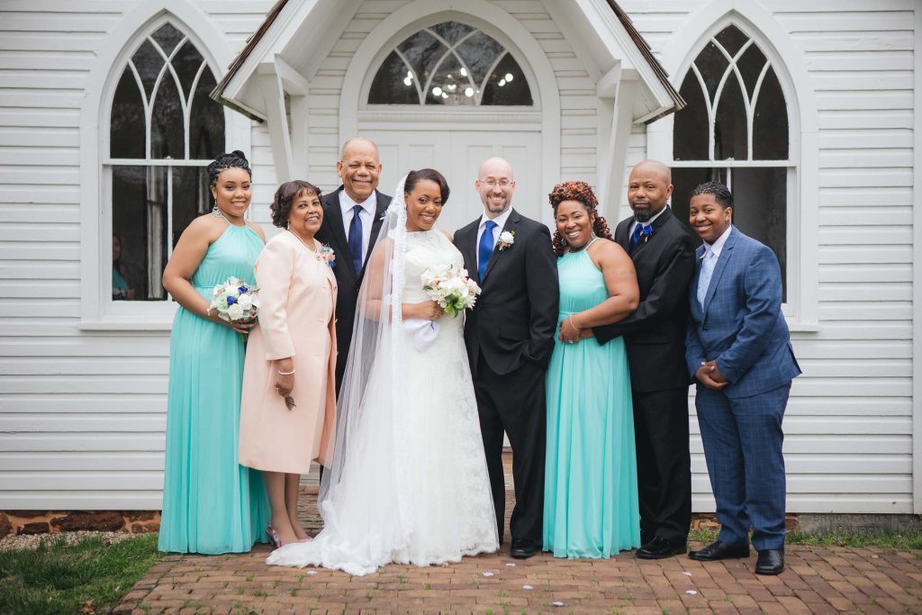 A wedding party posing in front of Dorsey Chapel.