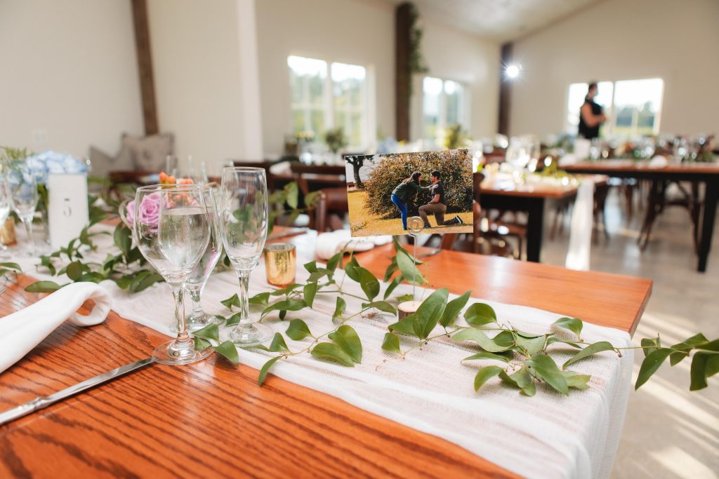 A table setting with flowers and greenery at a wedding reception in Virginia.