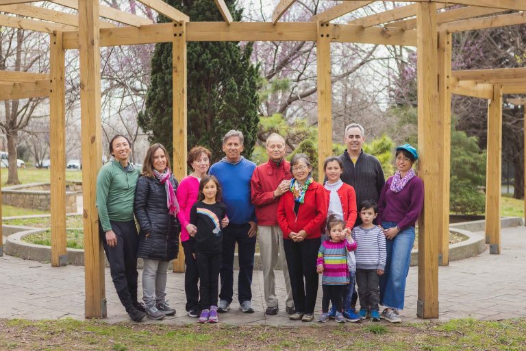 A group of people posing in front of a wooden gazebo at Wheaton's General Getty Neighborhood Park in Maryland.