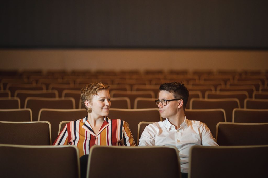 A man and woman sitting in the Old Greenbelt Theatre in Maryland.