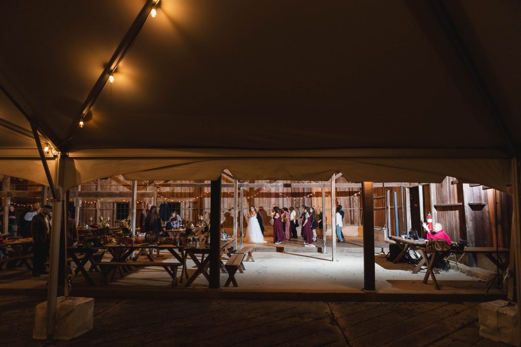 A wedding reception at night in the rustic charm of a barn, located in St Leonard, Maryland near Jefferson-Patterson Park.