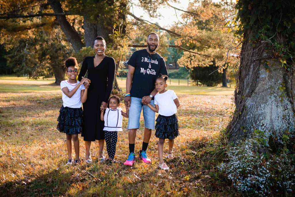 A family posing for a photo in a park in Crofton, Maryland.