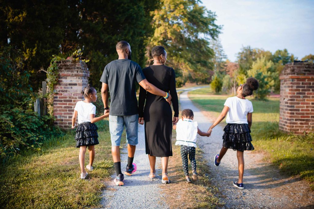 A black family walking down a dirt road in Crofton, Maryland.