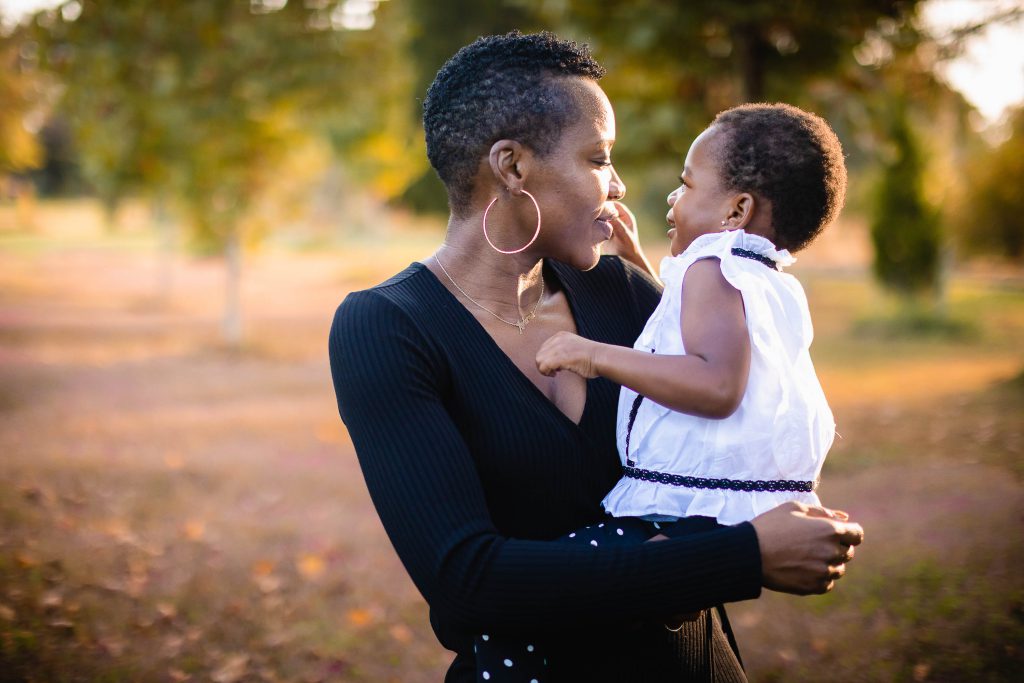 A black woman holding a little girl in Johns Hopkins House.