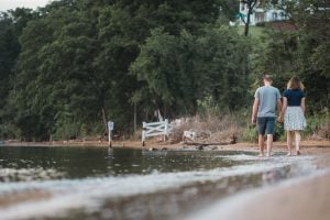 A couple walking along the shore of a lake in Jonas and Anne Catharine Green Park, Maryland.