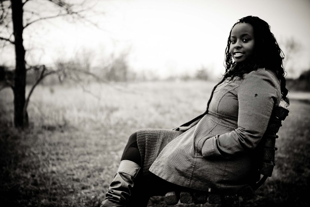 A black woman sitting on a bench at Lake Artemesia in College Park, Maryland.