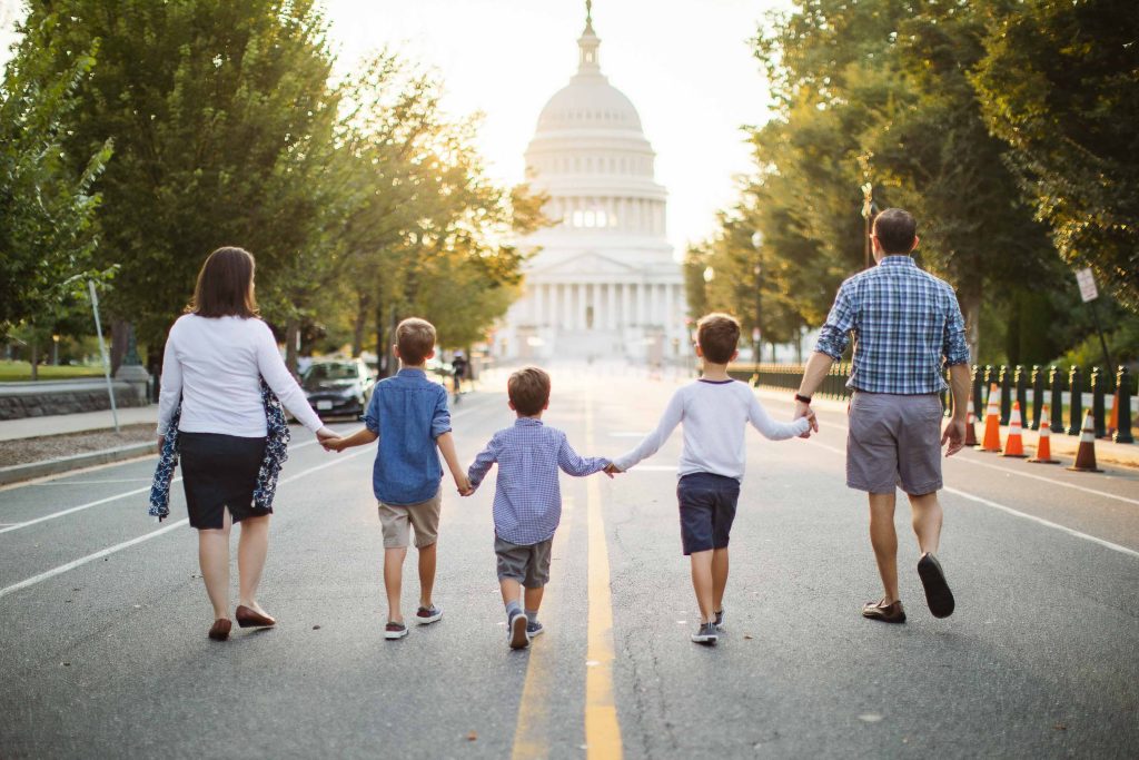 A family walking in front of the Capitol building in Washington DC.