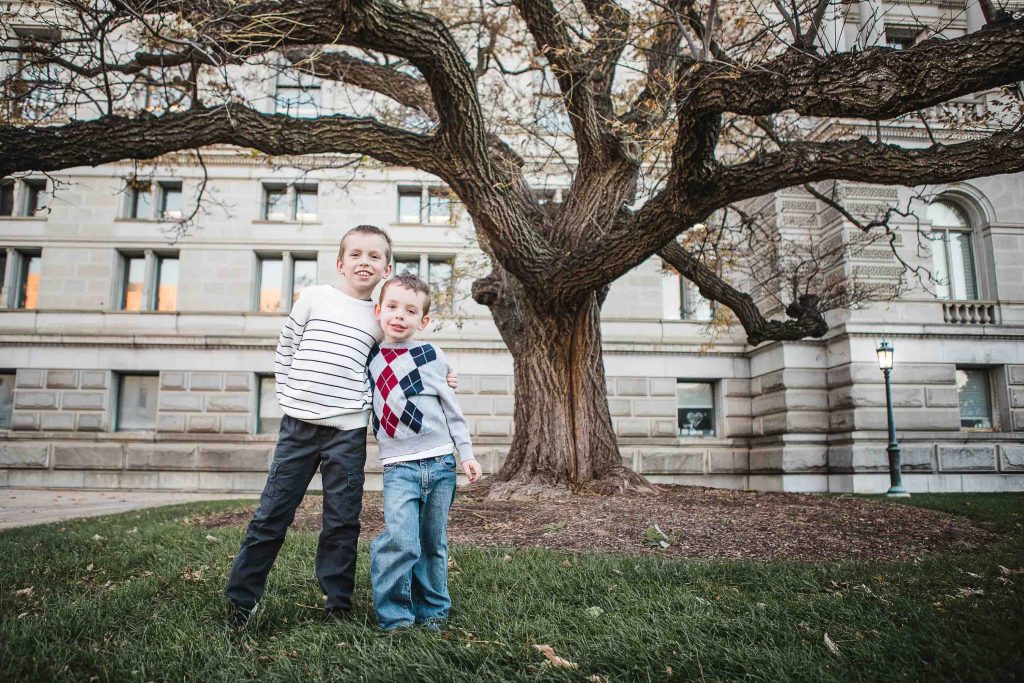 Two boys standing under a tree in front of the Library of Congress in Washington DC.