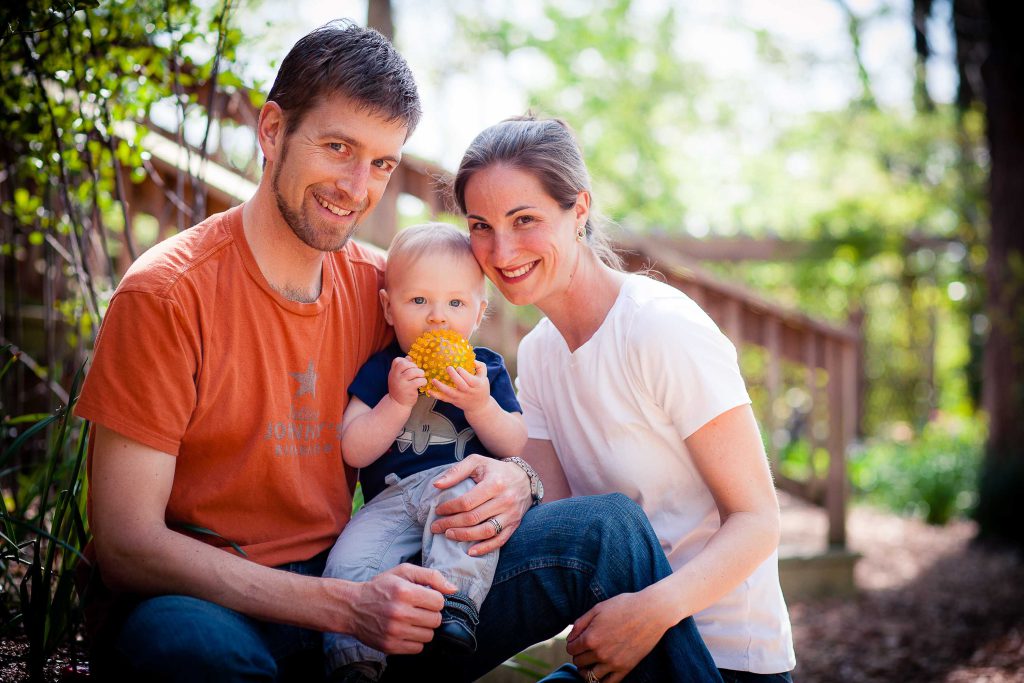 A man and a woman holding a baby at Locust Grove Nature Center in Bethesda, Maryland.