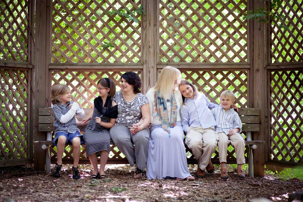 A family sits on a bench at Locust Grove Nature Center in Bethesda, Maryland.