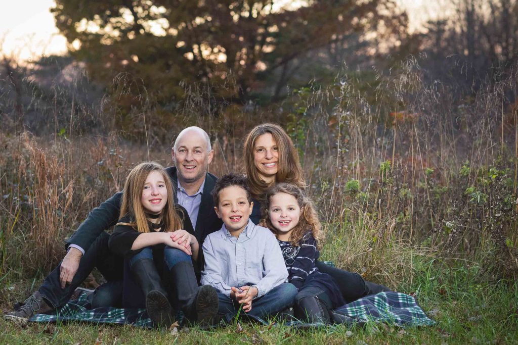 A family sits on a blanket at the Locust Grove Nature Center in Bethesda, Maryland.