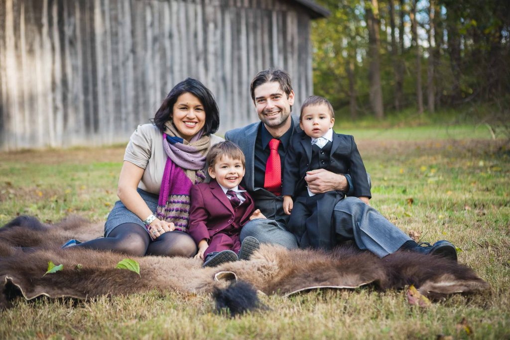 A family sits on a blanket in front of the Marietta House barn in Maryland.