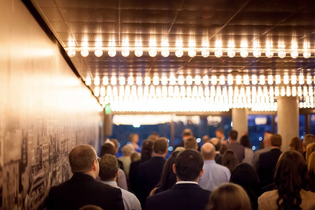 A crowd of people standing in the National Aquarium hallway.