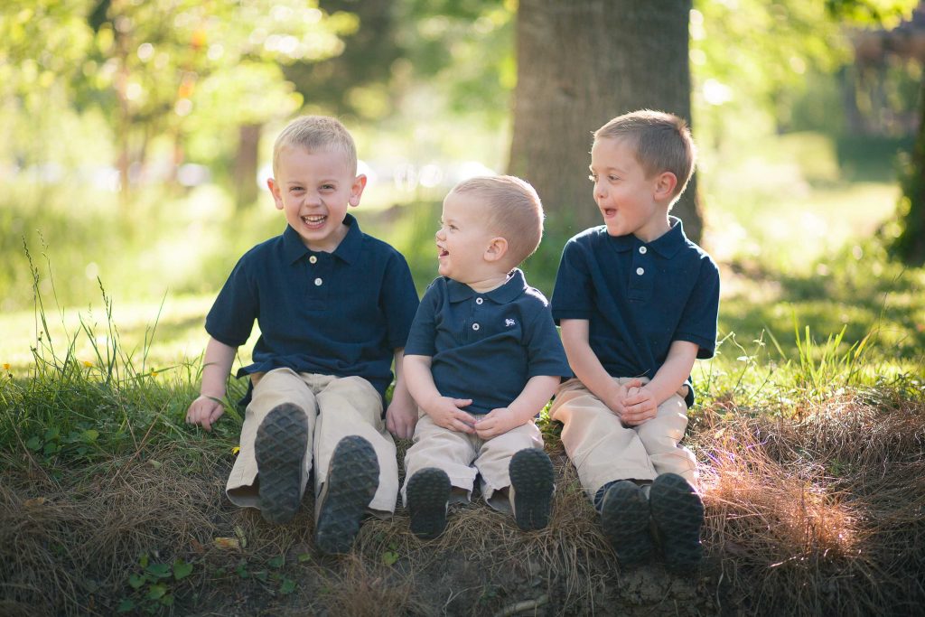 Three boys sitting in Wheaton Regional Park, Maryland.