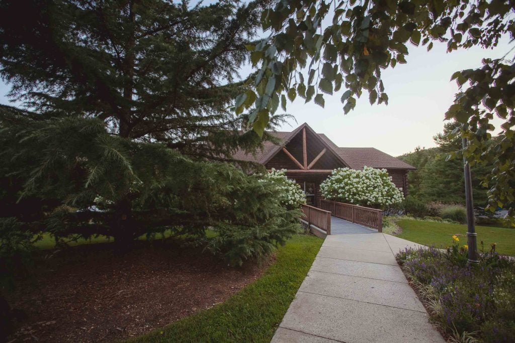 A wooden walkway leading to a log cabin in Germantown, Maryland.