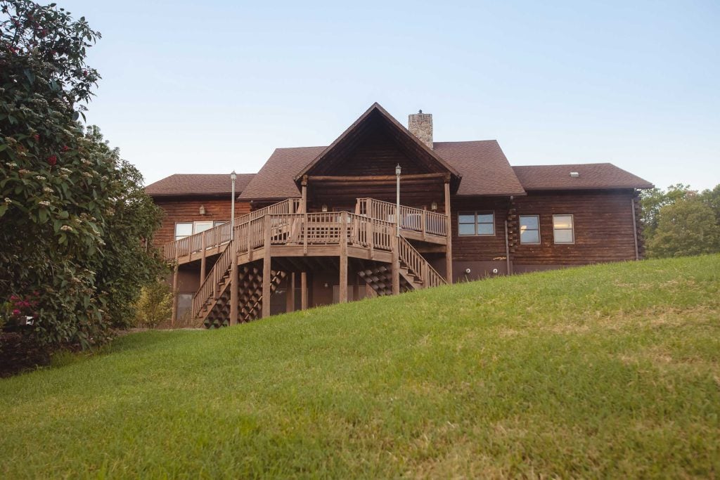 A large log home with a large deck located in Germantown, Maryland.