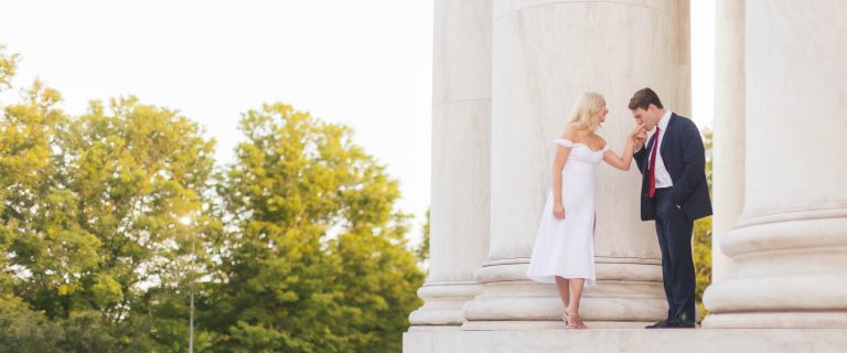 A couple kissing on the steps of the Jefferson Memorial in Washington DC.