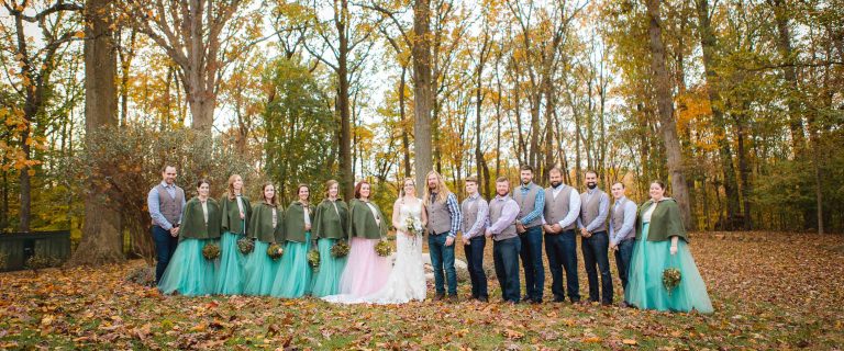 A group of bridesmaids and groomsmen posing for a photo at Liriodendron Mansion in Maryland's Bel Air.