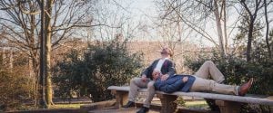 Two men laying on a bench in Meridian Hill Park, Washington DC.