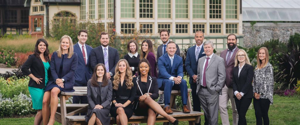 A group of business people posing on a bench in Rawlings Conservatory, Baltimore.
