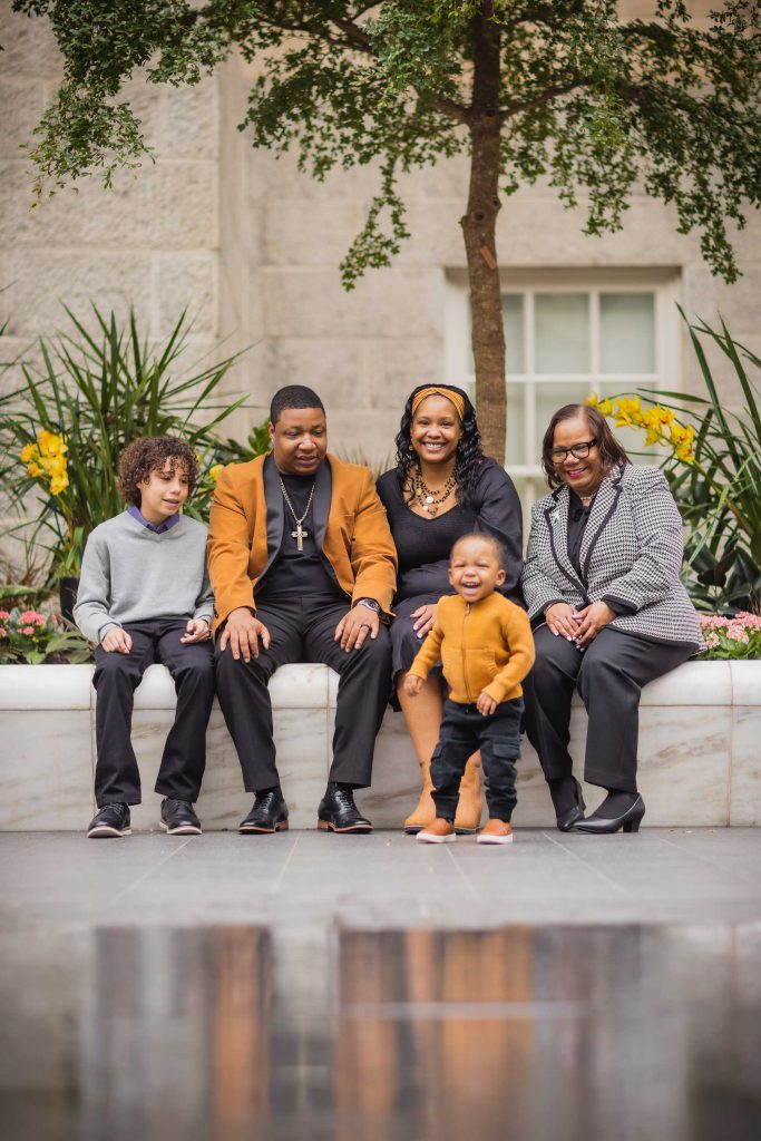 A family gathers on a bench outside the National Portraits Gallery.