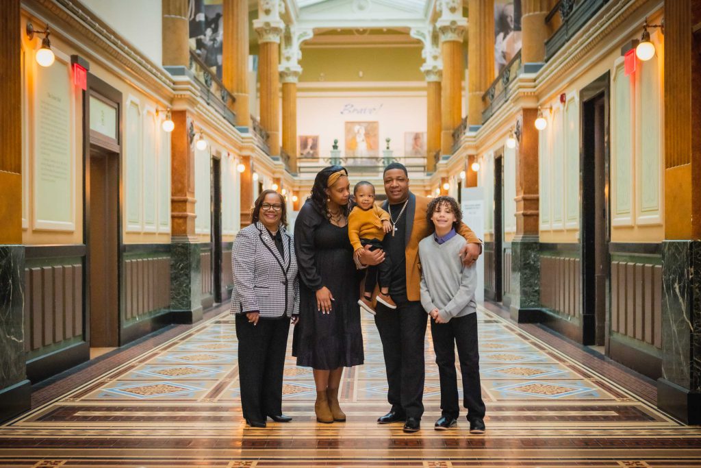A family posing in the National Portraits Gallery.