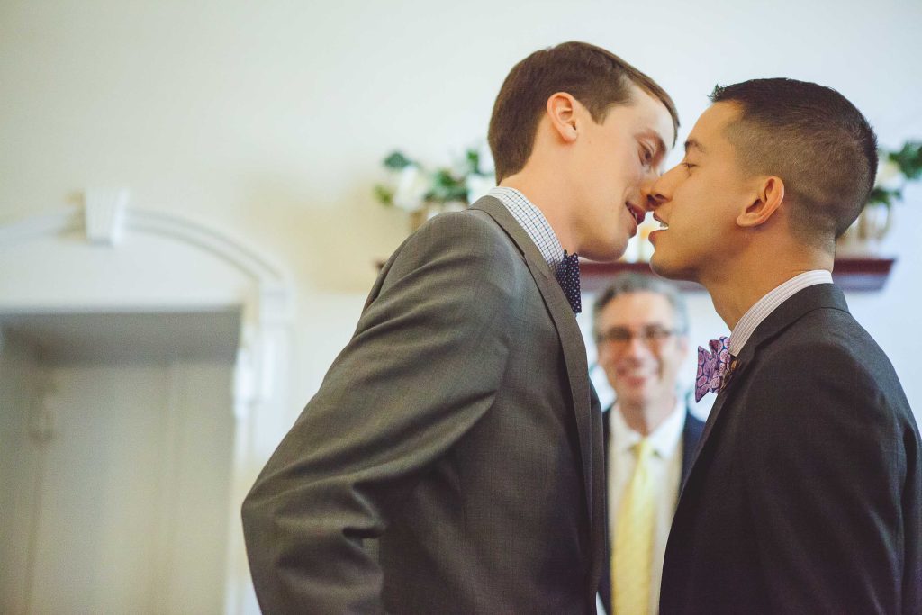 Two men in suits kissing each other in the Circuit Court for Anne Arundel County.