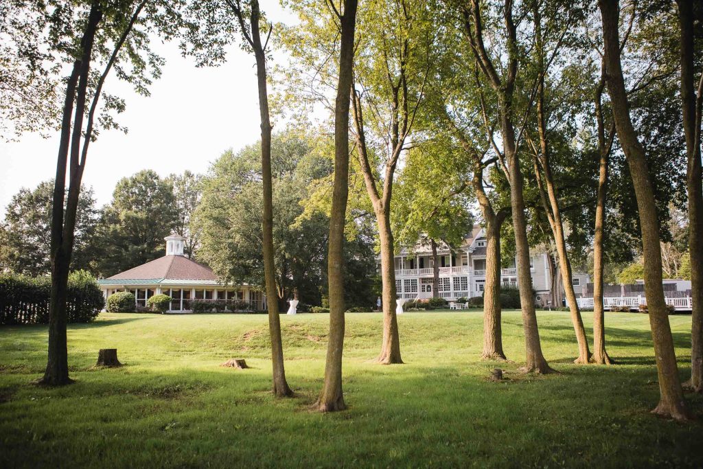 A grassy area with trees and a gazebo at Kent Island Resort in Stevensville, Maryland.