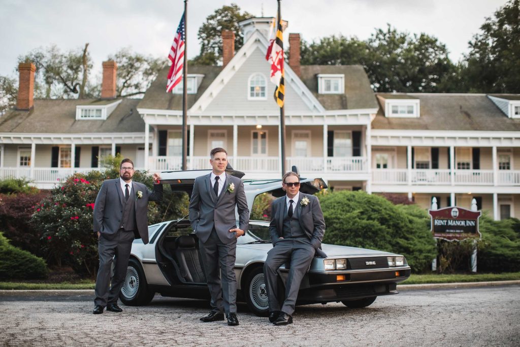 Three groomsmen standing next to a Delorean in front of a house in Stevensville, Maryland.