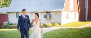 A bride and groom walking in front of a barn at Linganore Winecellars in Maryland's Mt. Airy.