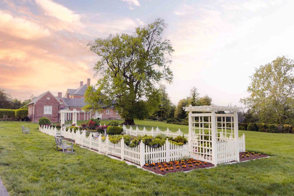 A white picket fence in front of Montpelier Mansion.