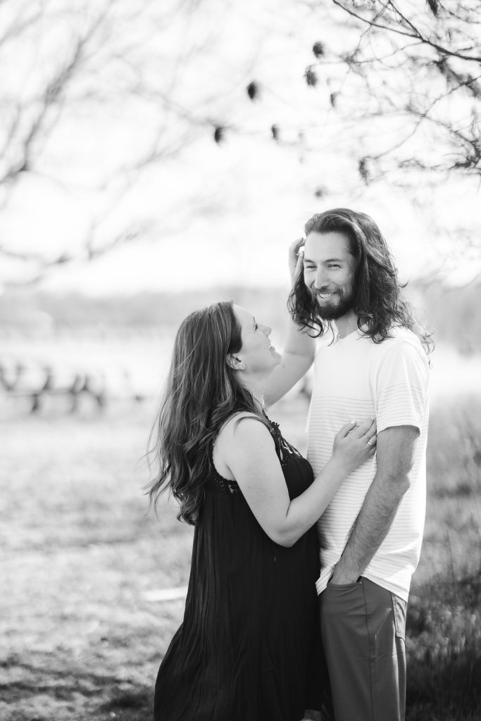 A black and white portrait photo of a couple in a field in Annapolis, Maryland.