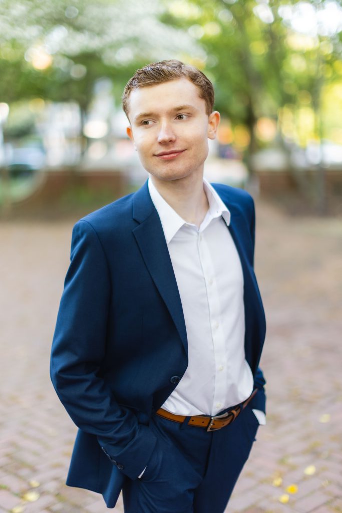 A High School Senior in a blue suit standing in Downtown Annapolis.