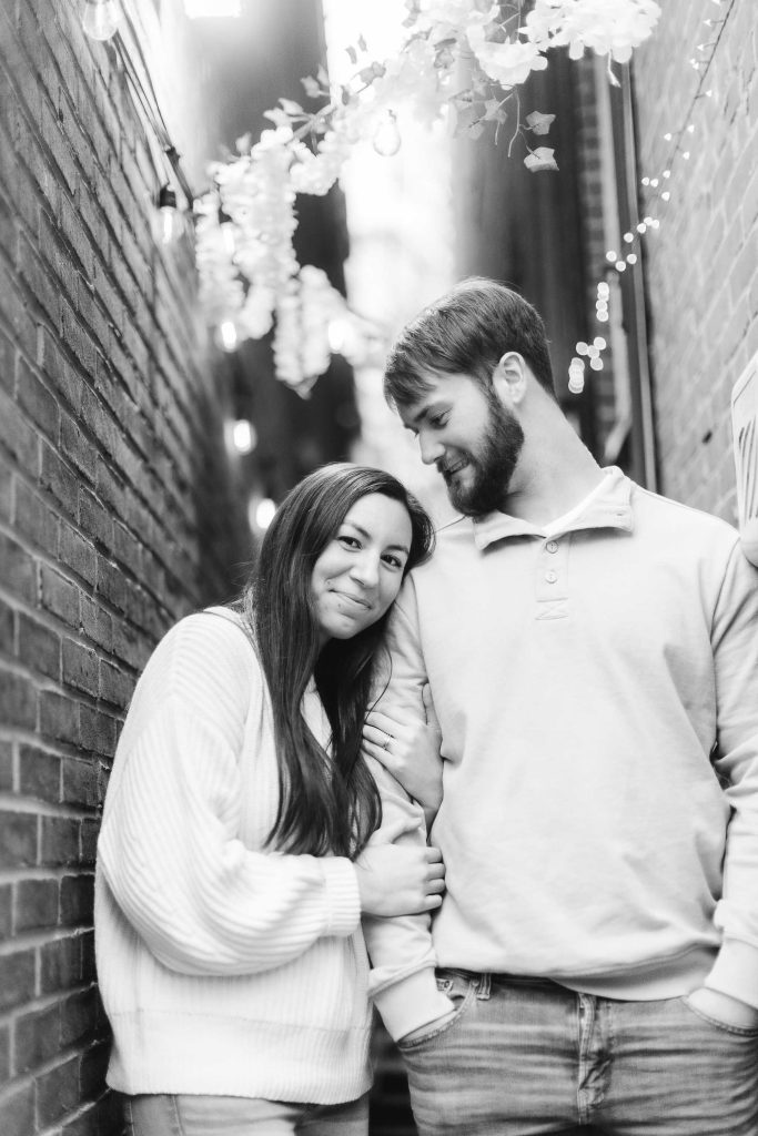 A black and white portrait of an engaged couple in Old Ellicott City.