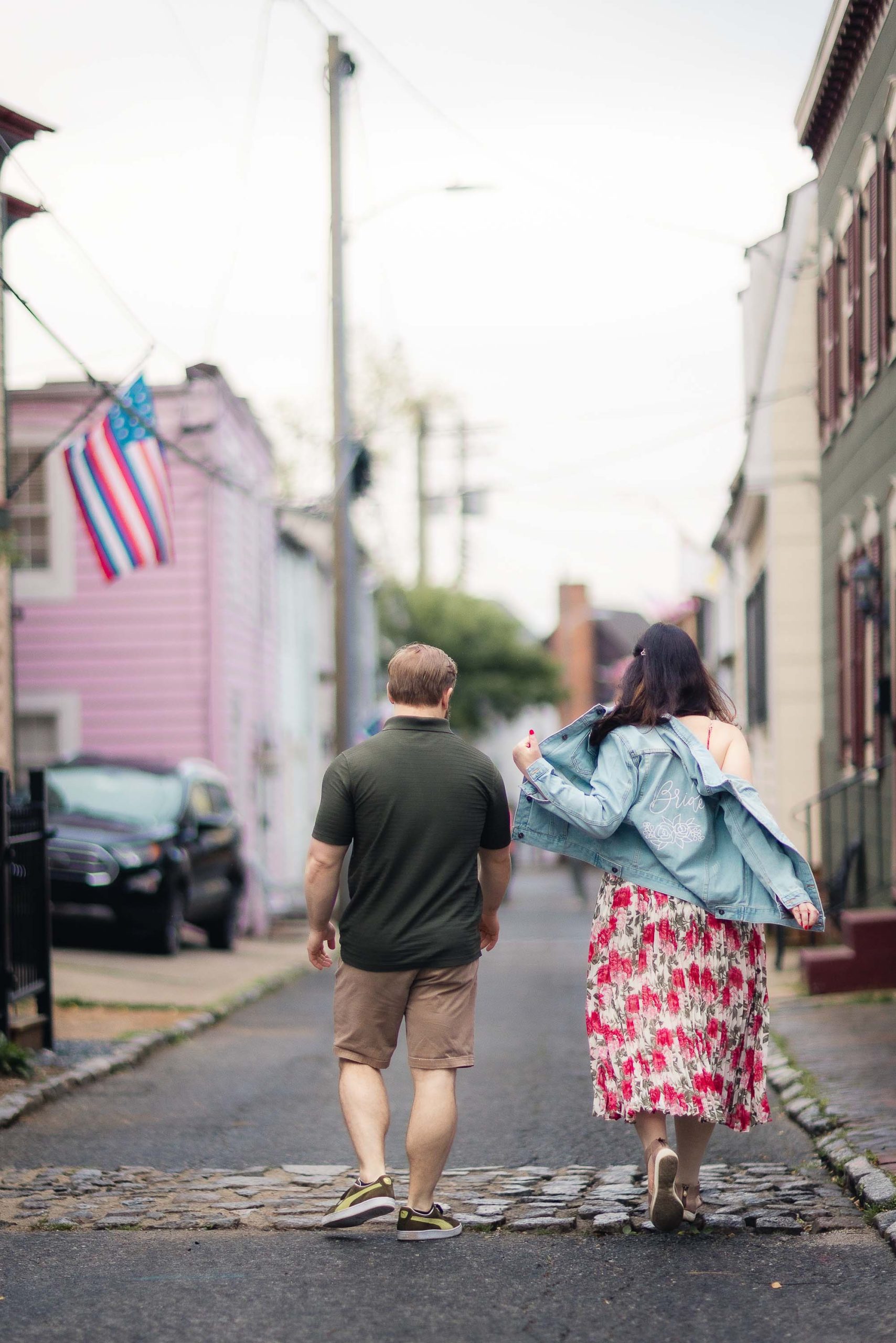An engaged couple taking engagement photos in downtown Annapolis.