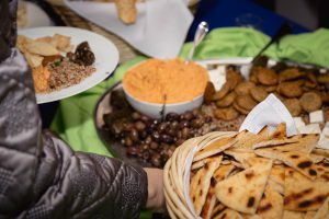 Spilled Milk Catering specializes in event vendor services for clients seeking a person holding a platter of food.