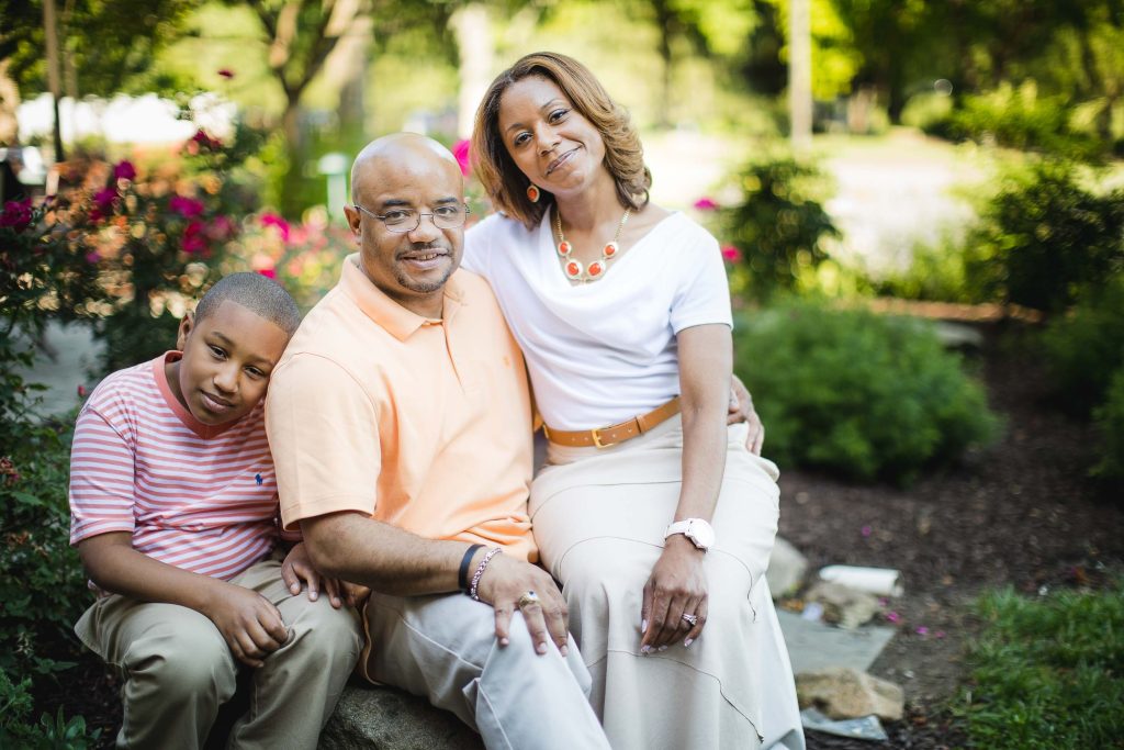 A black family sitting in a garden at Turf Valley Resort in Maryland.