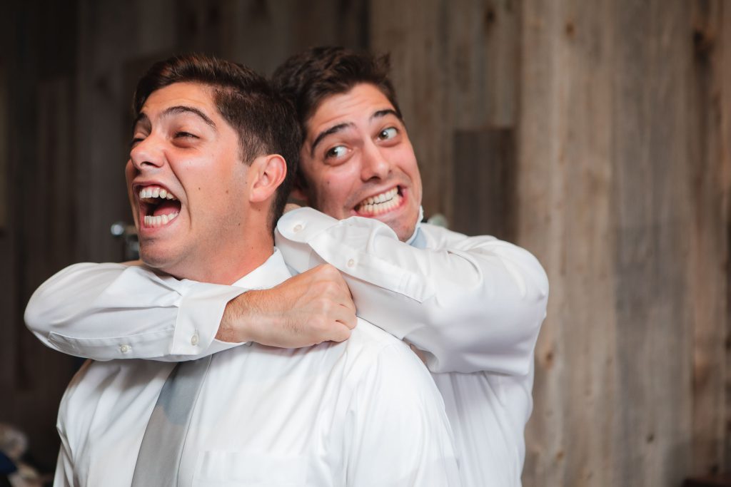 A man wearing a white shirt at a wedding.